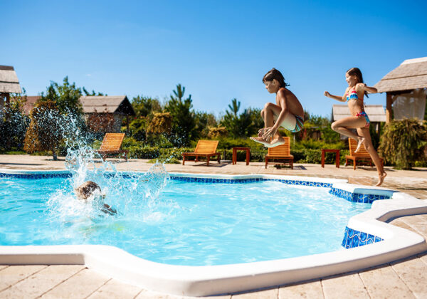 cheerful-children-rejoicing-jumping-swimming-pool-small)